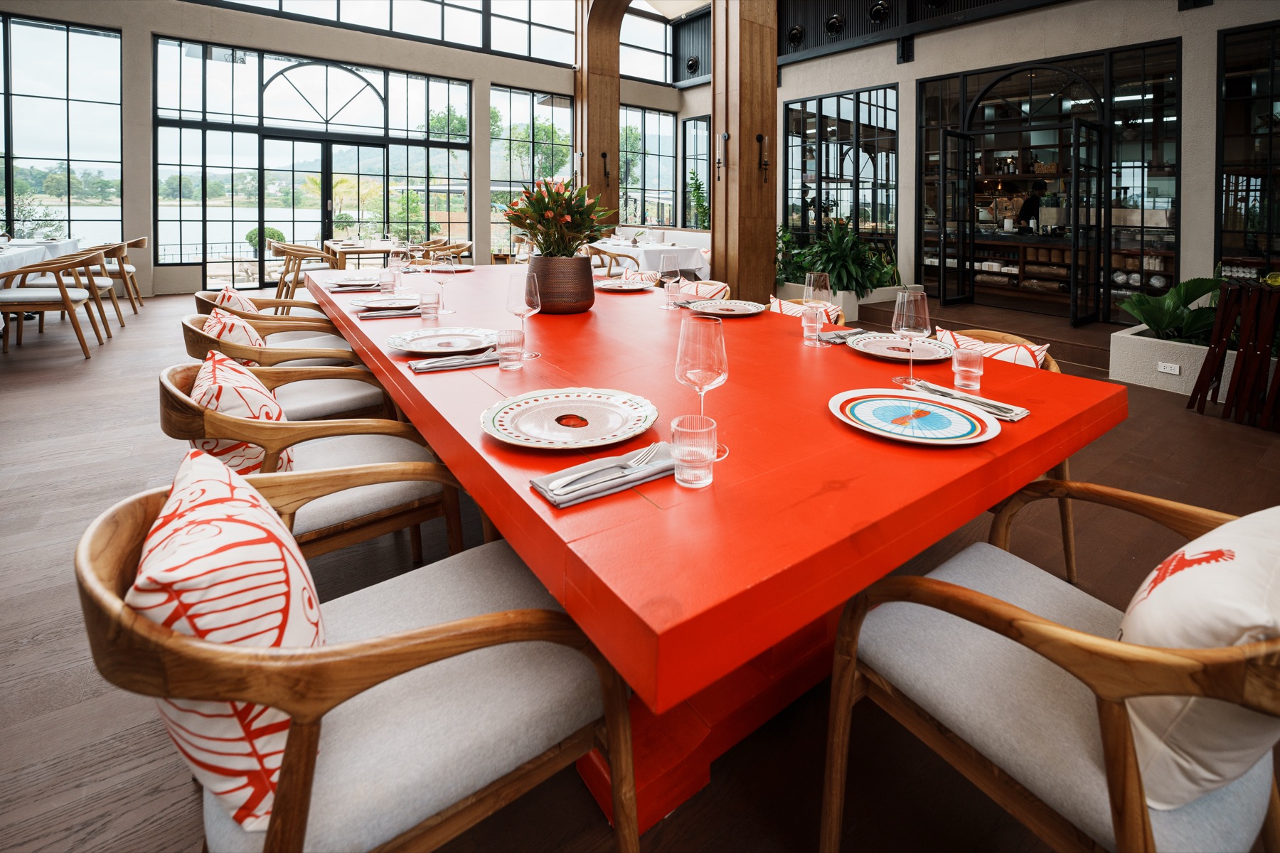 ETNA dining room with a red communal table by the windows